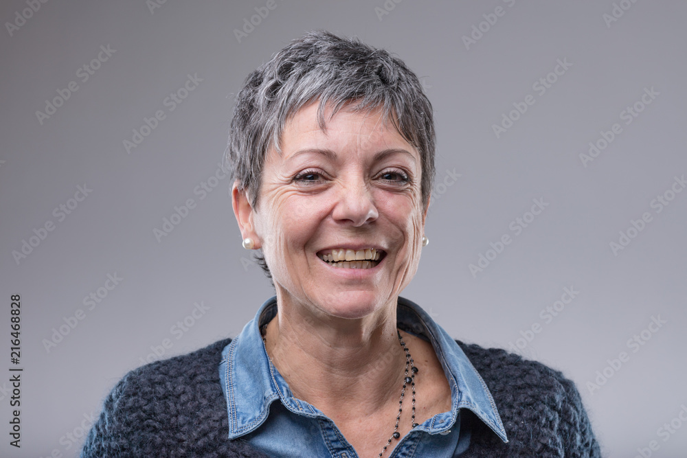 Obraz premium Smiling happy older woman with short hair