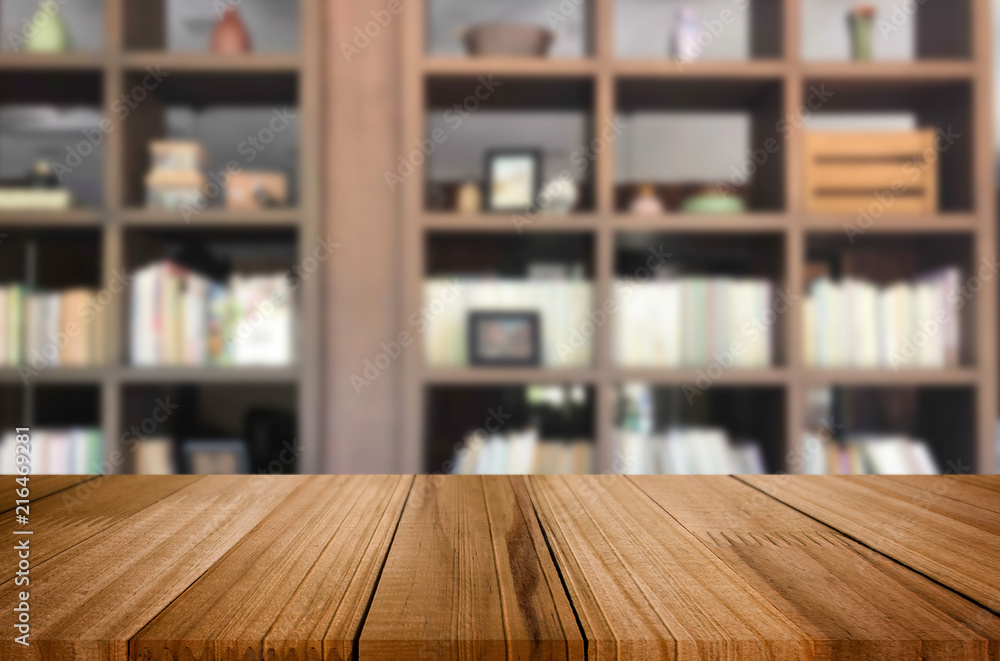 Wooden board empty table space platform in front of blurred library Of The background - can be used for display or montage your products. Mock up for display of product. Wooden board empty table space platform in front of blurred library Of The background - can be used for display or montage your products. Mock up for display of product.