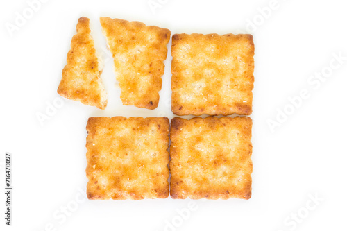 Crackers broken in half top view on white background.
