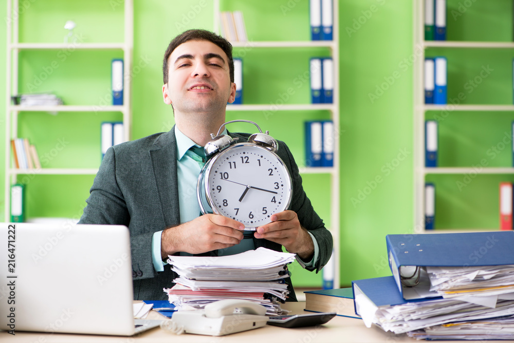Businessman angry with excessive work sitting in the office in t Businessman angry with excessive work sitting in the office in t