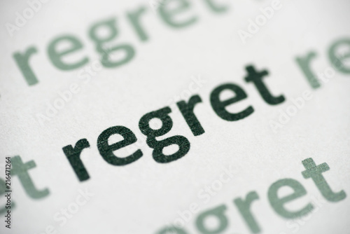 word regret printed on paper macro