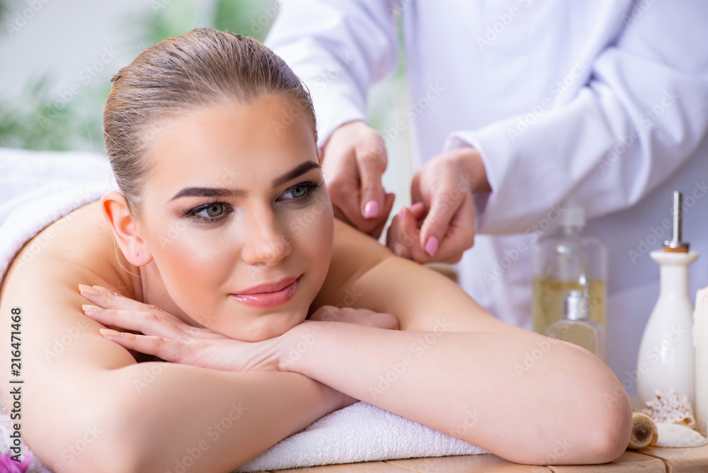 Woman during massage session in spa