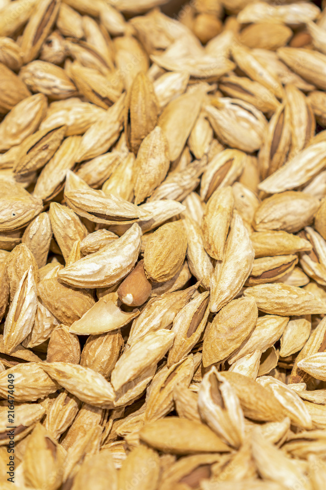 Background of shelled spanish almonds, seen from directly above and in full frame. Macro shot. unpeeled almonds. vertical photo. Background of shelled spanish almonds, seen from directly above and in full frame. Macro shot. unpeeled almonds. vertical photo.