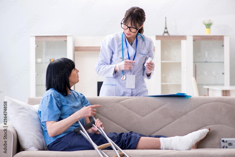 Fototapeta premium Doctor examining old mature woman after incident
