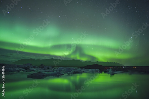 Northern Lights over glacier lagoon in Iceland. Up north northern lights show. © Gheorghe