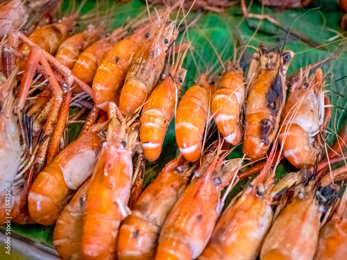  Grilled giant river prawn or big shrimp on banana leaf with selective focus.A recommended menu for tourists when they come to Thailand. The prawn is served with spicy seafood sauce.