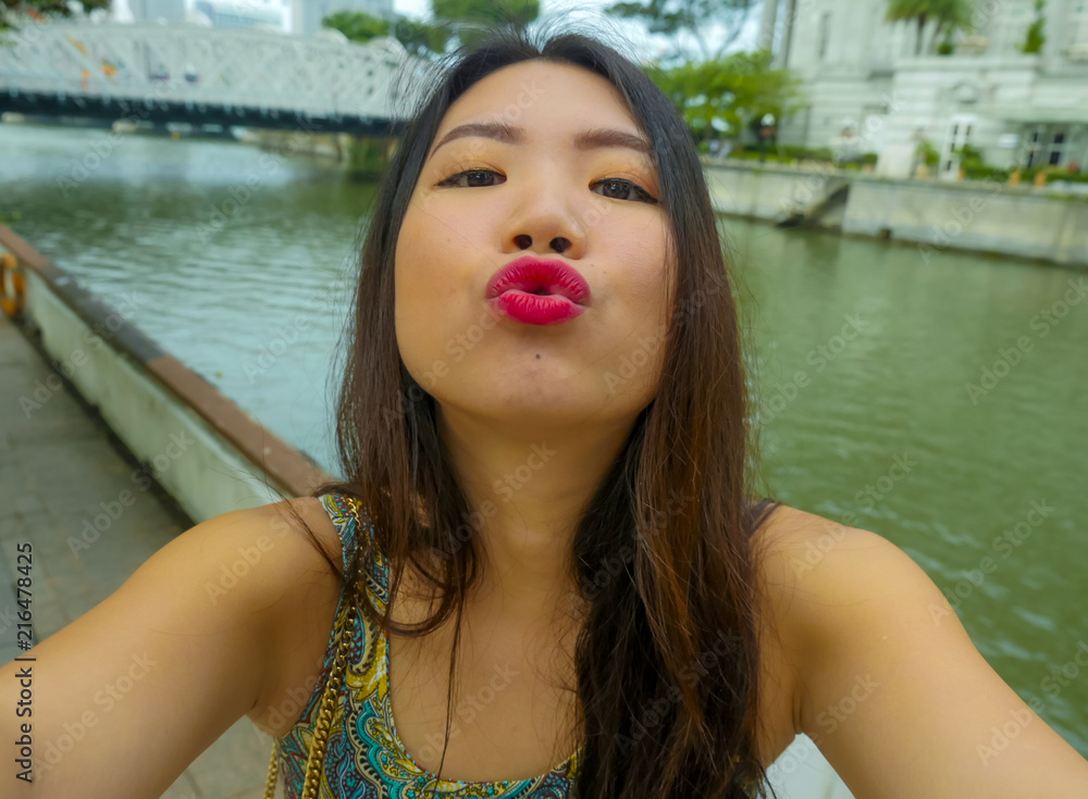 young beautiful and happy Asian Korean tourist woman taking selfie photo  with mobile phone smiling cheerful having fun sending kiss and enjoying  sweet holidays trip Stock Photo | Adobe Stock
