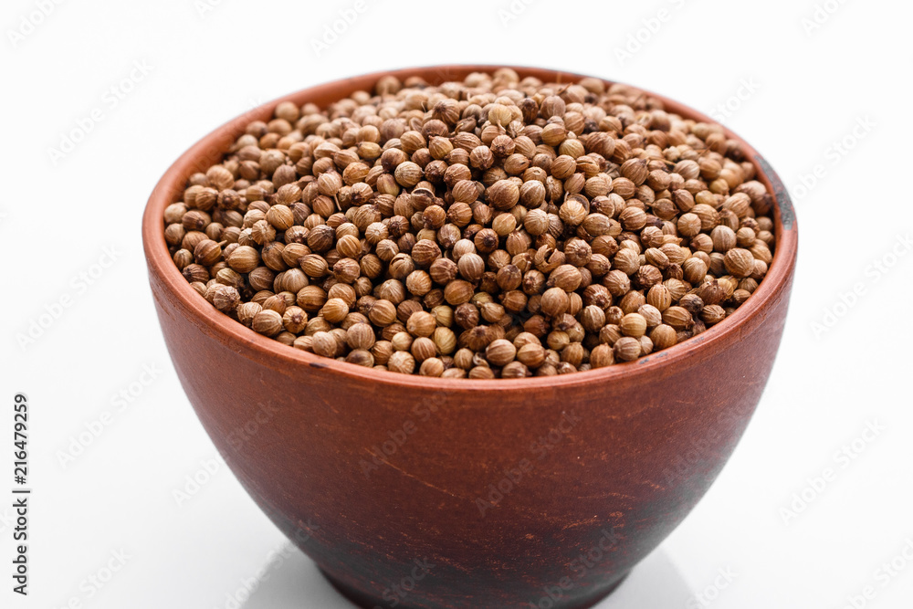 fragrant coriander seeds on a white background fragrant coriander seeds on a white background