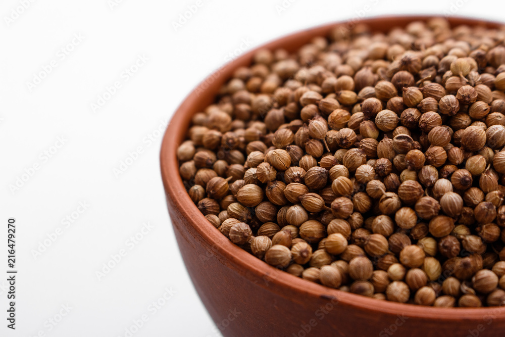 fragrant coriander seeds on a white background fragrant coriander seeds on a white background
