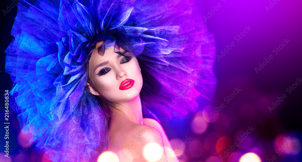 Fashion model woman in colorful bright lights posing. Portrait of beautiful sexy girl with trendy makeup and colorful hairdo. Art design