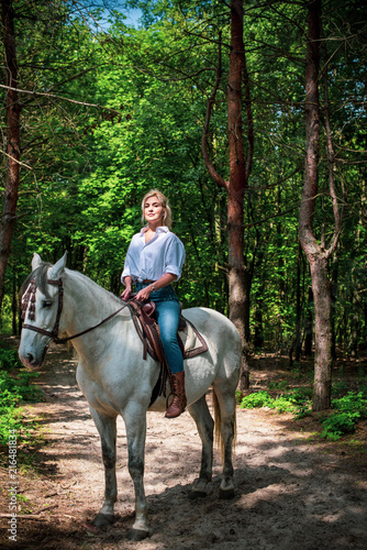 Pretty girl lady at countryside with white horse. A beautiful rider and horse. Artistic Photography at horse farm. Attractive girl riding on horse rural location  © T.Den_Team