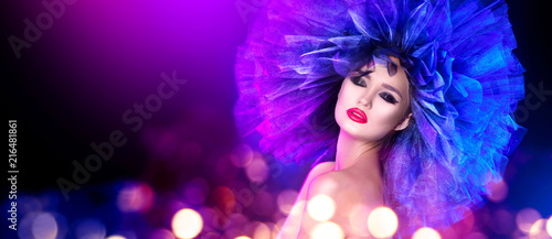 Fashion model woman in colorful bright lights posing. Portrait of beautiful sexy girl with trendy makeup and colorful hairdo. Art design
