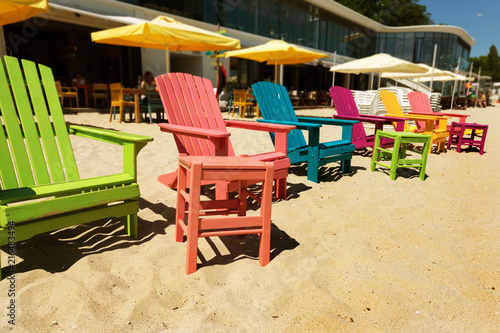 Beach, multi-colored beach chairs, stools and chaise lounges. Beach umbrellas and beach furniture as a concept of relaxation, holiday, summer, spa © Aleksandr Lesik