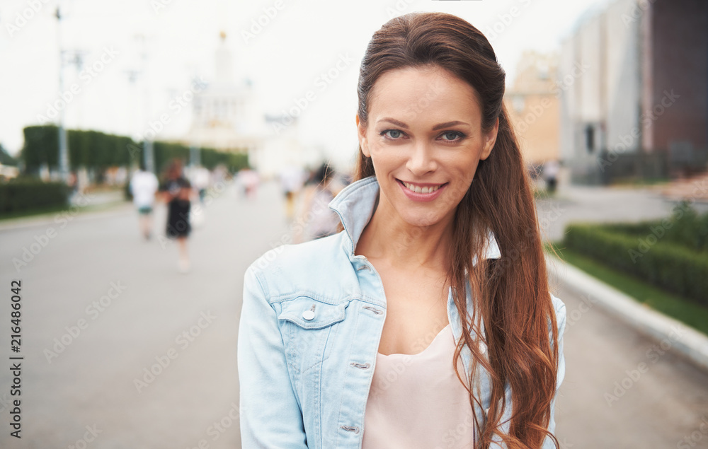 Portrait of happy woman standing in the street
