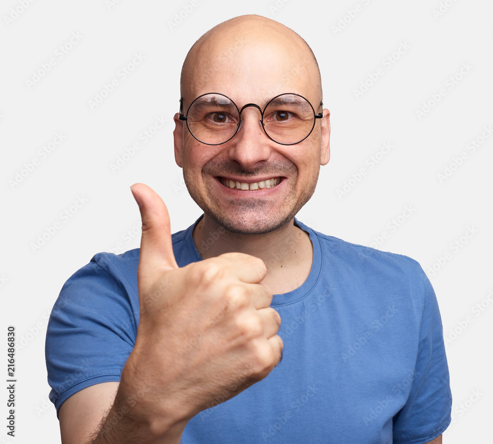 Bald man in glasses showing thumbs up Stock Photo | Adobe Stock