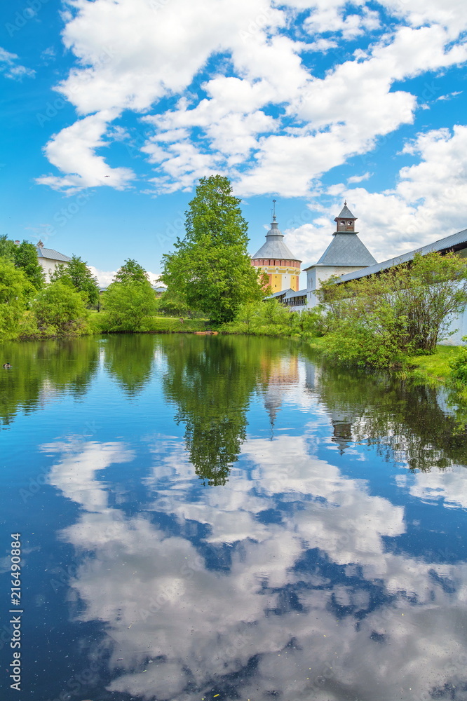 The monastery tower and the wall in Vologda are reflected in the lake