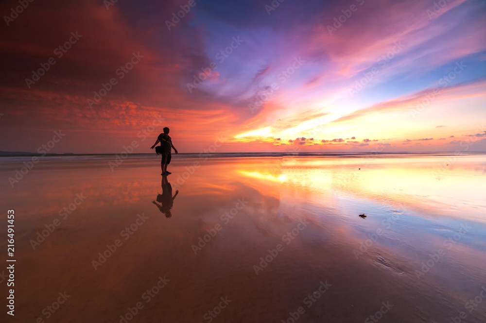 Sunrise with beautiful reflection. silhouette of unknown people appear on the image. Sunrise with beautiful reflection. silhouette of unknown people appear on the image.