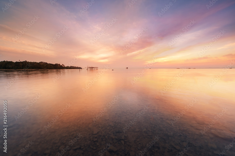 sunrise Seascape with beautiful reflection for background. soft focus due to long expose.