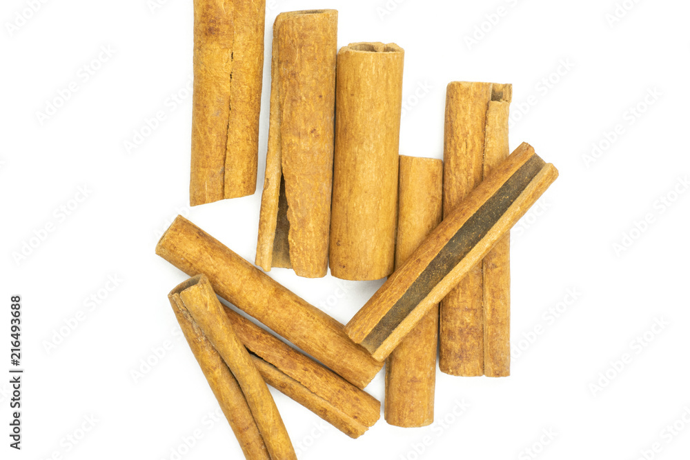 Lot of whole dry brown cinnamon stick flatlay isolated on white background Lot of whole dry brown cinnamon stick flatlay isolated on white background
