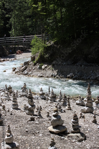 stone towers at an alpine river in bavaria, germany