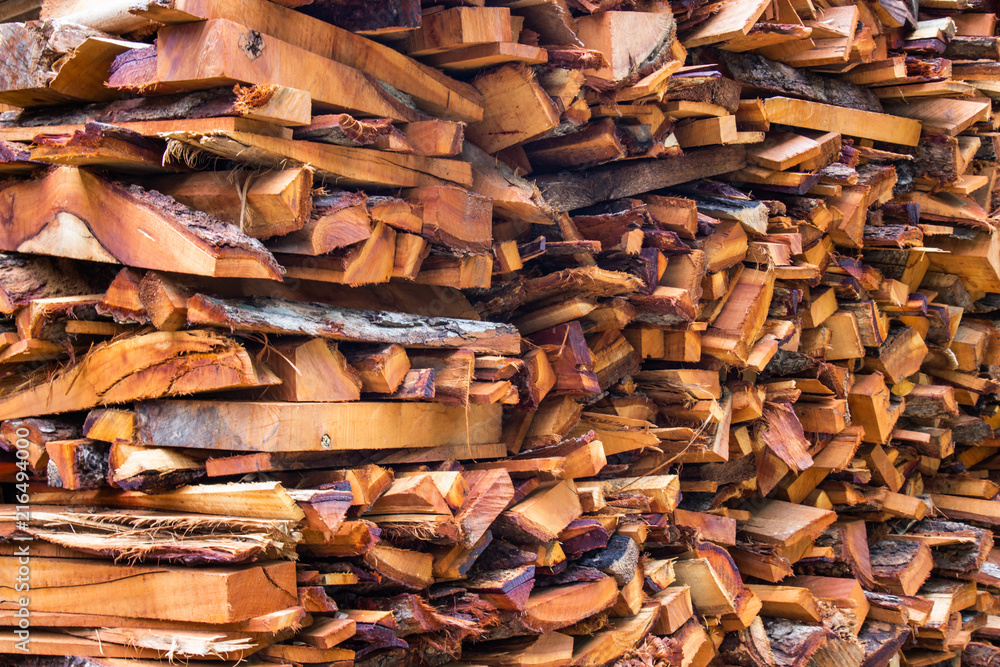 Firewood wooden logs big chopped trunks stacked pile dry for used fireplace in winter. Firewood wooden logs big chopped trunks stacked pile dry for used fireplace in winter.