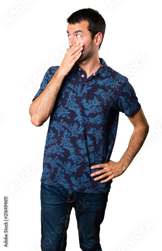 Brunette man covering his mouth on white background