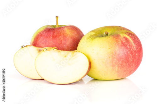 Group of two whole two slices of fresh red apple james grieve variety isolated on white background