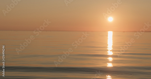 small waves on a beach at sunset © GCapture