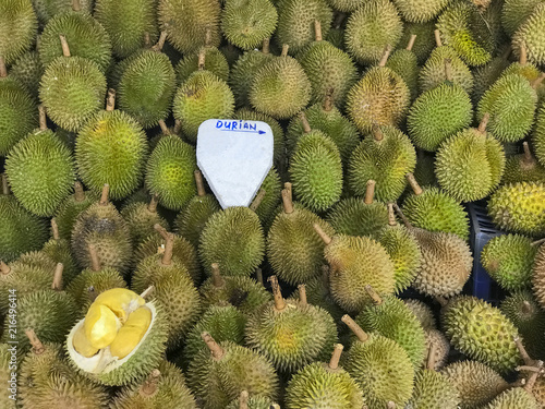 Yellow and green ripe durians being sold at a local market in Malaysia. photo