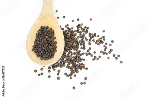 peppercorns in spoon heap on white background.