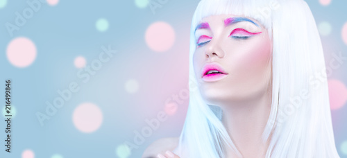 Beauty fashion model girl portrait with white hair, pink eyeliner, gradient lips. Futuristic art makeup in white, blue and pink colors © Subbotina Anna