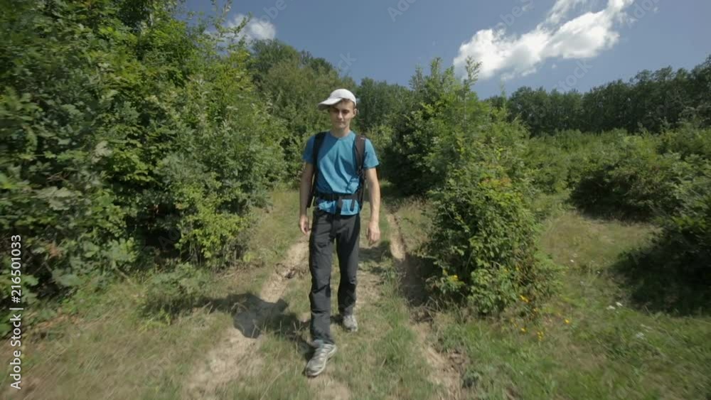 Young man hiking into the forest Young man hiking into the forest