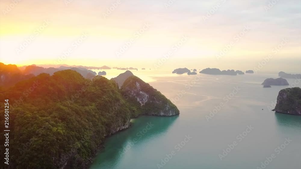 Aerial moving in shot of sunrise view at HaLongBay, Vietnam. Aerial moving in shot of sunrise view at HaLongBay, Vietnam.