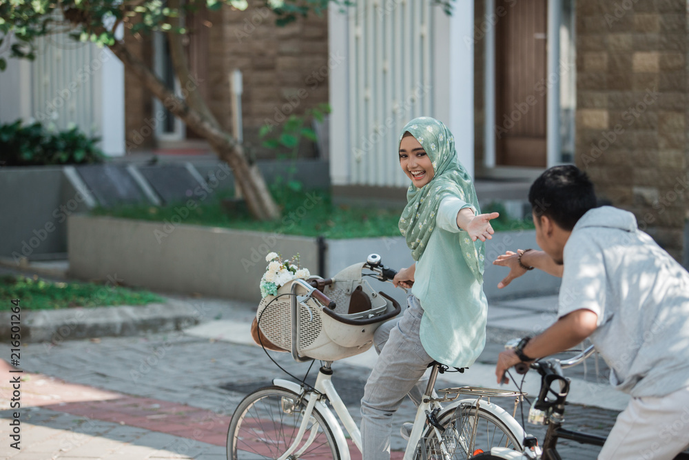 muslim couple riding a bike