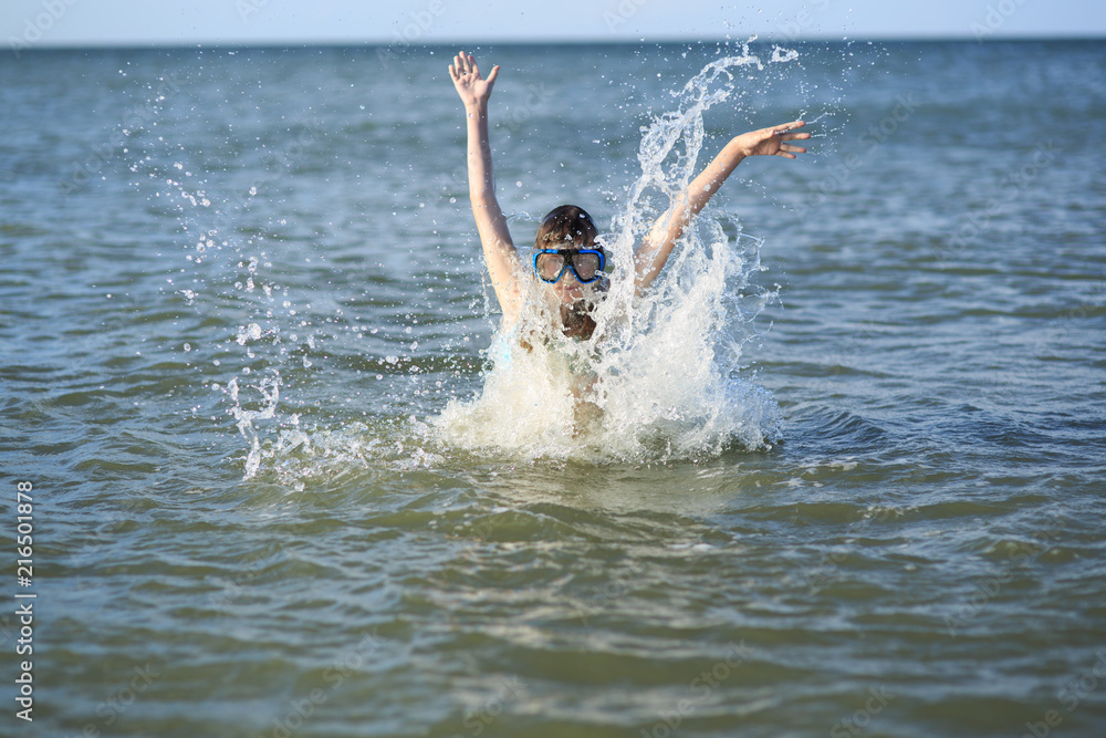 girl of thirteen in a mask for diving into the sea