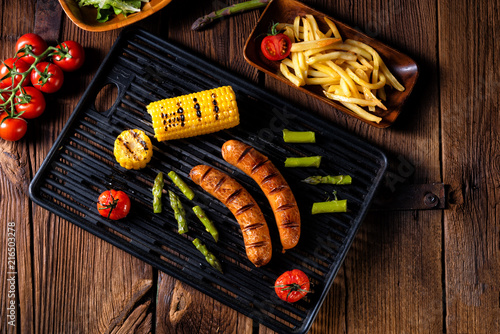 grilled krakauer with french fries and green salad photo