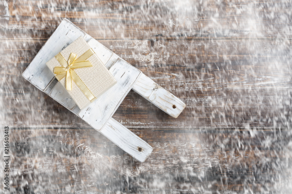 Old wooden toy sled with gift boxes on wooden background. Old wooden toy sled with gift boxes on wooden background.