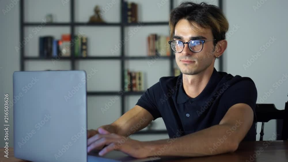 Handsome Man Typing on the Keybord, Using Laptop, Office Manager, Trider, Stock Market, Checking the Social Networks Handsome Man Typing on the Keybord, Using Laptop, Office Manager, Trider, Stock Market, Checking the Social Networks