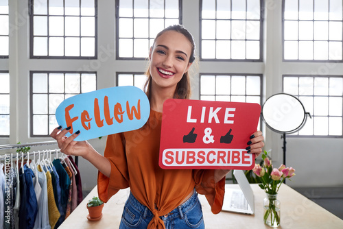 Vlogger telling viewers to follow her channel photo