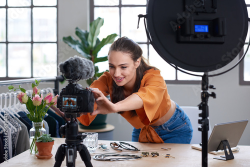 Online content creator vlogger adjusting her recording equipment photo