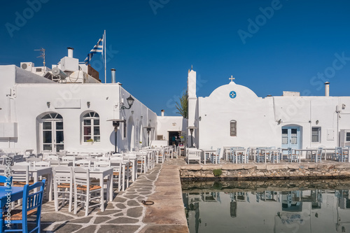 Typical Greek taverna tables in picturesque Naoussa town, Paros island, Cyclades, Greece