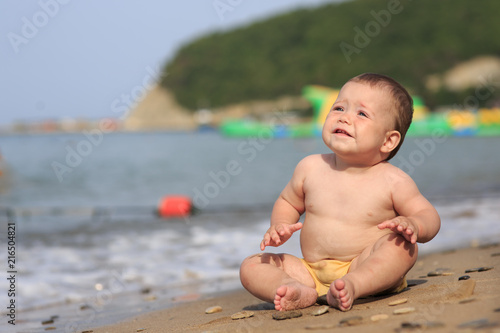 Baby playing on the sandy beach