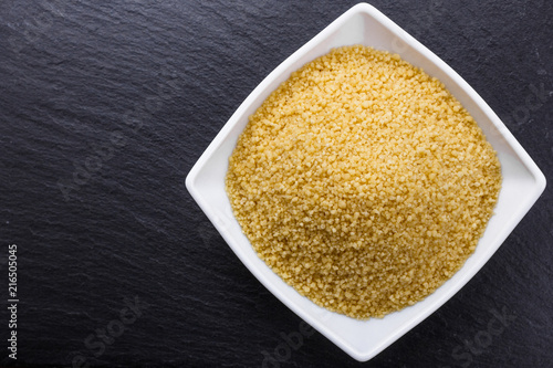 fresh couscous on a dark stone background photo