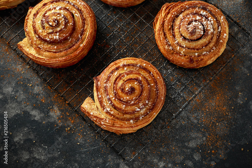 Tableau sur toile Freshly baked cinnamon swirls with icing sugar