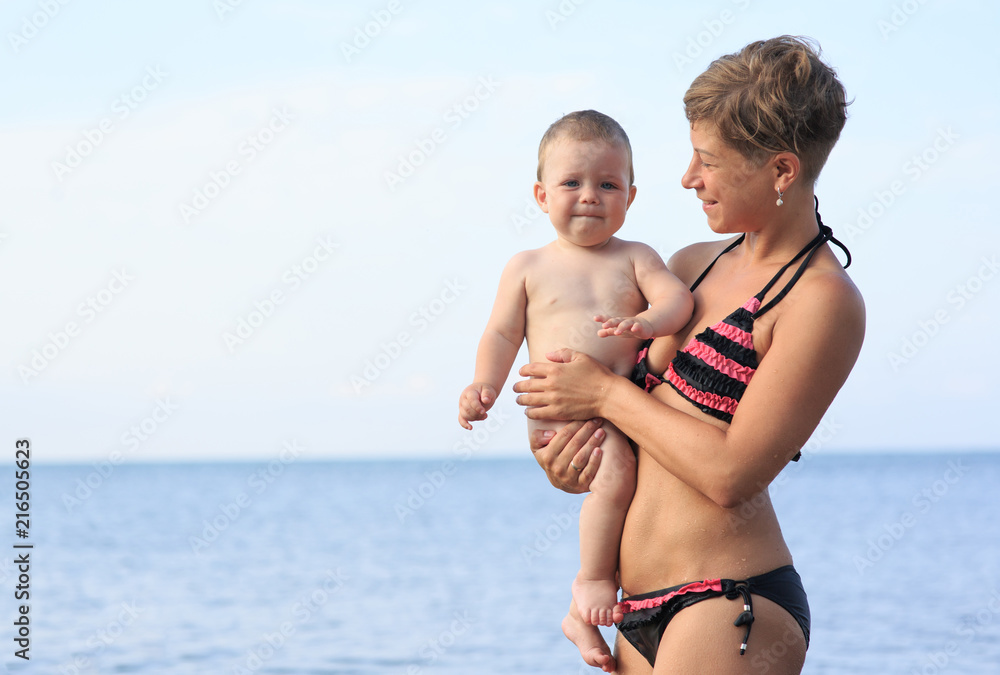 Mom with a baby on the sea