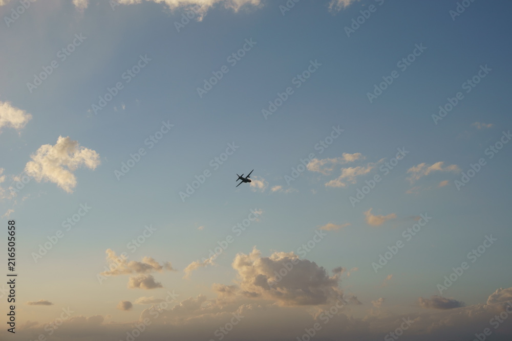 Fototapeta premium View of a plane gliding in blue sky