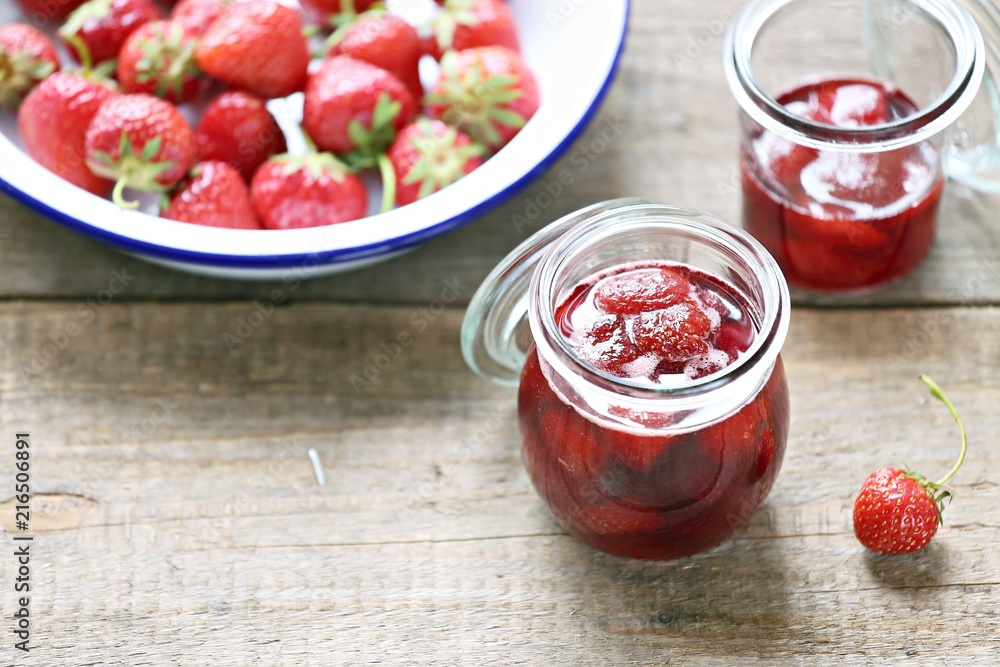Strawberry marmalade. Homemade strawberry jam in glass jar overhead rustic wooden table. Copy space Strawberry marmalade. Homemade strawberry jam in glass jar overhead rustic wooden table. Copy space