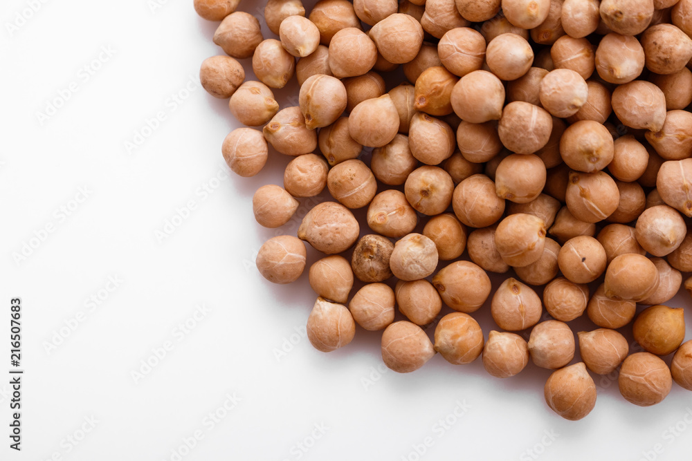 uncooked chickpeas on a white acrylic background uncooked chickpeas on a white acrylic background