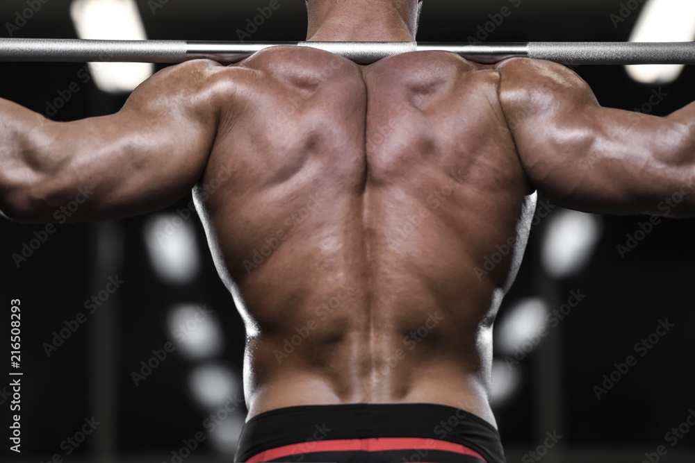 Handsome strong bodybuilder athletic men pumping up muscles with dumbbells Handsome strong bodybuilder athletic men pumping up muscles with dumbbells