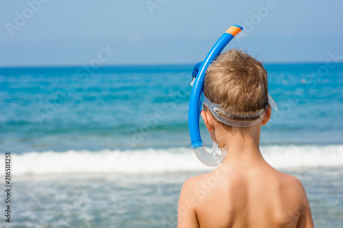Boy in snorkelling mask. Back view. Space for text
